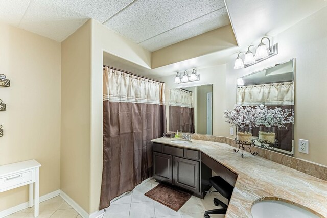 full bathroom featuring double vanity, tile patterned flooring, and a sink