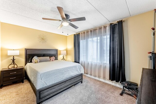 bedroom featuring ceiling fan and light carpet