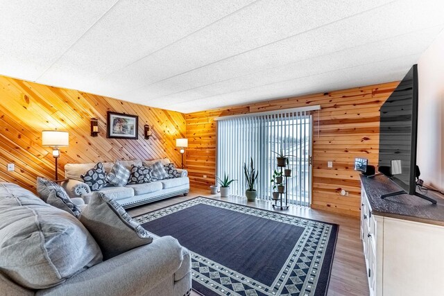 living room featuring wooden walls and wood finished floors