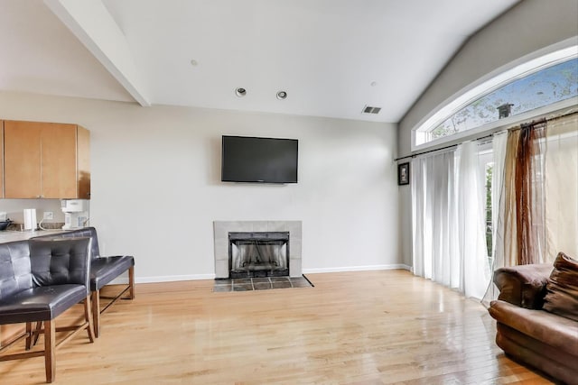 6527 S Drexel Ave, Chicago, IL 60637 - living room featuring light wood-style flooring, a tiled fireplace, baseboards, and high vaulted ceiling