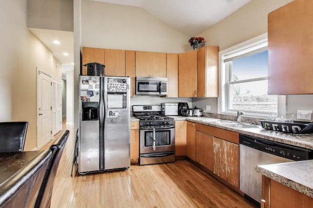 6527 S Drexel Ave, Chicago, IL 60637 - kitchen with stainless steel appliances, a sink, light wood-type flooring, and vaulted ceiling