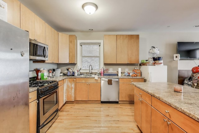 6527 S Drexel Ave, Chicago, IL 60637 - kitchen featuring appliances with stainless steel finishes, a sink, light wood-style floors, and light stone countertops