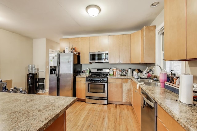 6527 S Drexel Ave, Chicago, IL 60637 - kitchen featuring stainless steel appliances, light brown cabinets, a sink, and light wood-style floors