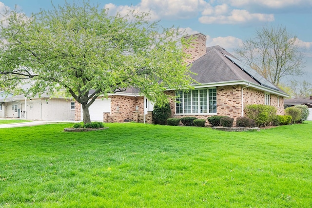 524 Meadow Ln, Beecher, IL 60401 - ranch-style home featuring a chimney, solar panels, a front yard, brick siding, and an attached garage