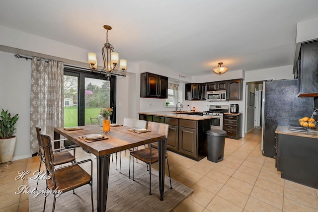 dining space featuring light tile patterned floors, a chandelier, and healthy amount of natural light