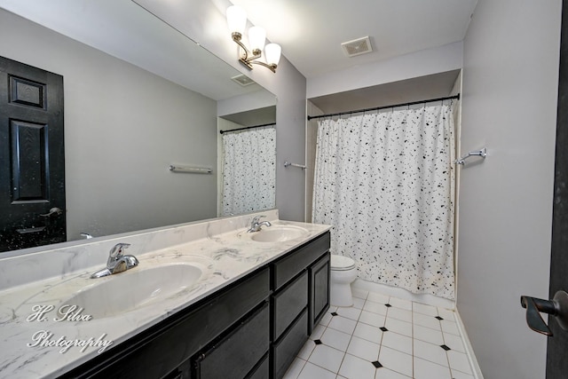 full bath featuring toilet, double vanity, curtained shower, and tile patterned flooring