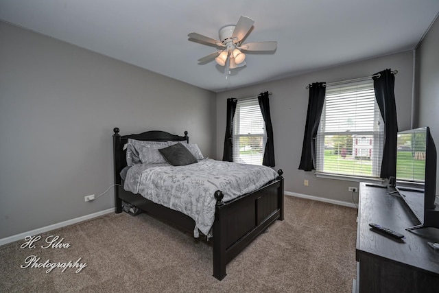 carpeted bedroom with baseboards and a ceiling fan