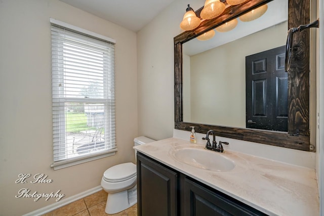 half bathroom featuring toilet, tile patterned flooring, vanity, and baseboards