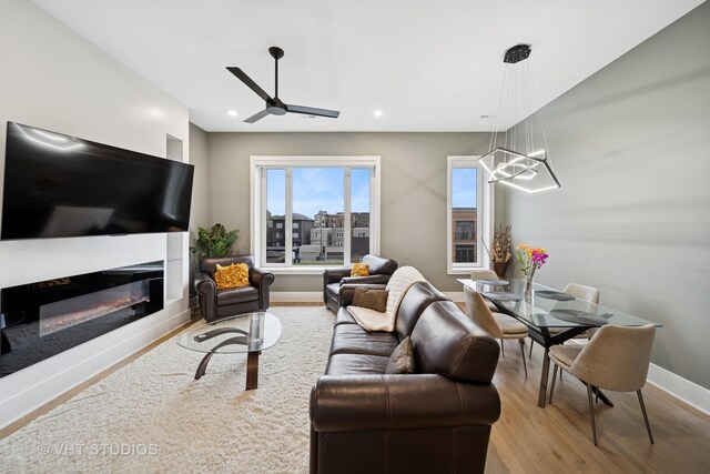 4816 S St Lawrence Ave Unit 302, Chicago, IL 60615 - living room featuring wood finished floors, baseboards, a ceiling fan, a glass covered fireplace, and recessed lighting