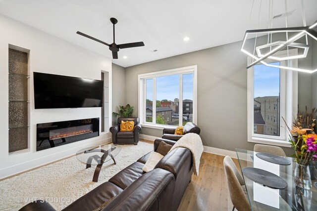 4816 S St Lawrence Ave Unit 302, Chicago, IL 60615 - living area with wood finished floors, ceiling fan, baseboards, a glass covered fireplace, and recessed lighting