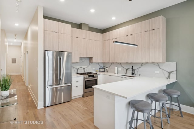 4816 S St Lawrence Ave Unit 302, Chicago, IL 60615 - kitchen with appliances with stainless steel finishes, light brown cabinets, modern cabinets, a sink, and a kitchen breakfast bar