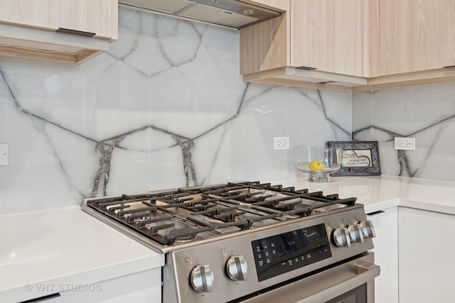 4816 S St Lawrence Ave Unit 302, Chicago, IL 60615 - kitchen view of stainless steel range with gas cooktop, light countertops, wall chimney exhaust hood, light brown cabinetry, and backsplash