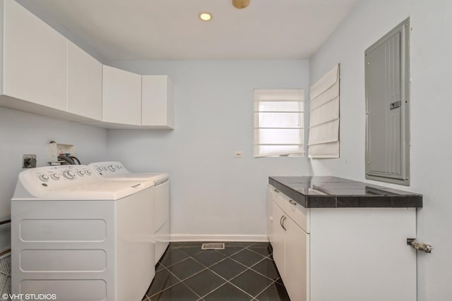 laundry area with electric panel, washing machine and clothes dryer, cabinet space, dark tile patterned flooring, and recessed lighting