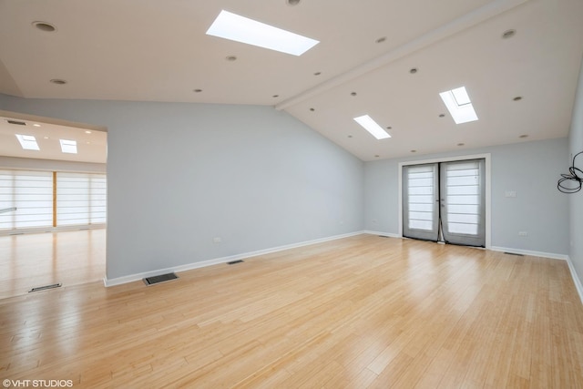 spare room with light wood-style floors, baseboards, and visible vents