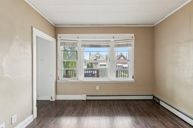 empty room with crown molding, healthy amount of natural light, a baseboard radiator, baseboard heating, and hardwood / wood-style floors