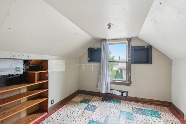 bonus room featuring vaulted ceiling and baseboards