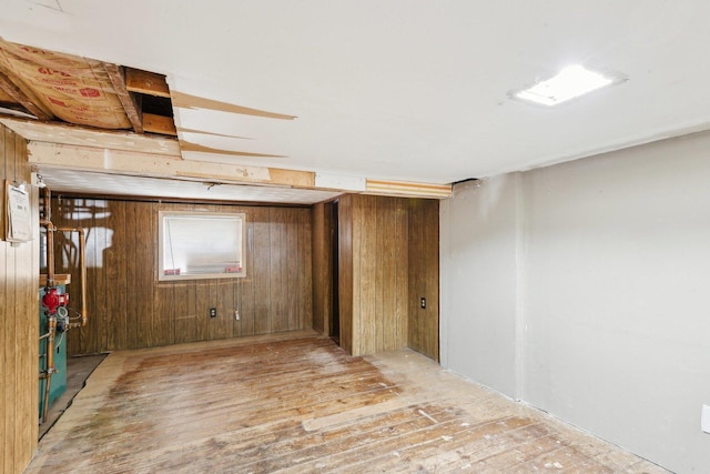 basement with wood finished floors and wooden walls