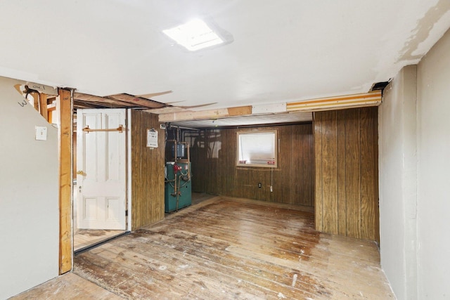 basement with wood-type flooring and wood walls