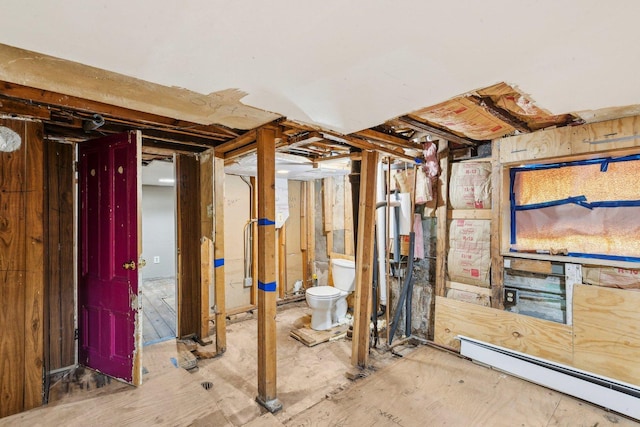unfinished basement featuring a baseboard radiator