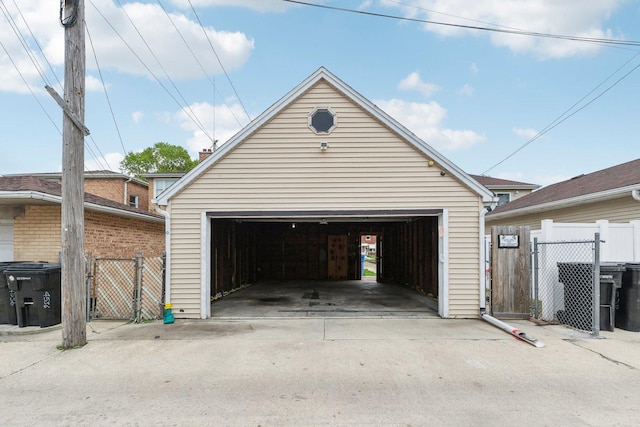 detached garage featuring fence