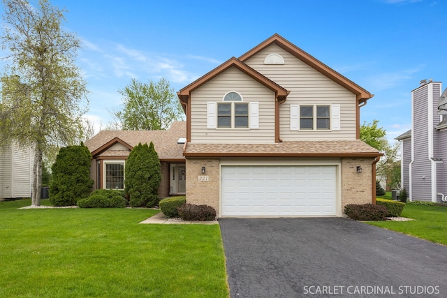 221 Ashley Ct, Oswego, IL 60543 - traditional home featuring brick siding, a garage, asphalt driveway, and a front yard