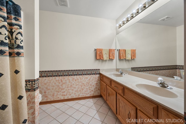 221 Ashley Ct, Oswego, IL 60543 - full bathroom featuring double vanity, tile patterned floors, and baseboards