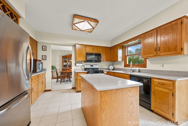 221 Ashley Ct, Oswego, IL 60543 - kitchen with black appliances, light countertops, a sink, and a kitchen island