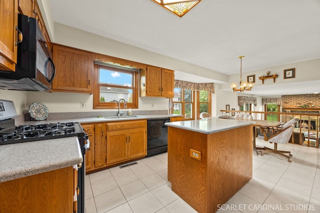 221 Ashley Ct, Oswego, IL 60543 - kitchen featuring black appliances, a sink, brown cabinetry, a chandelier, and a center island