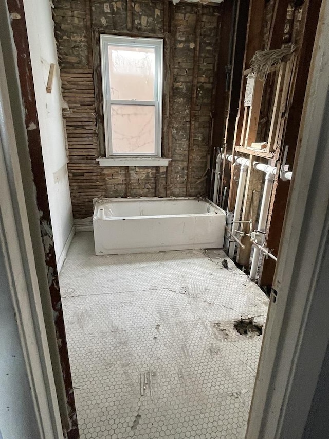 bathroom with a soaking tub