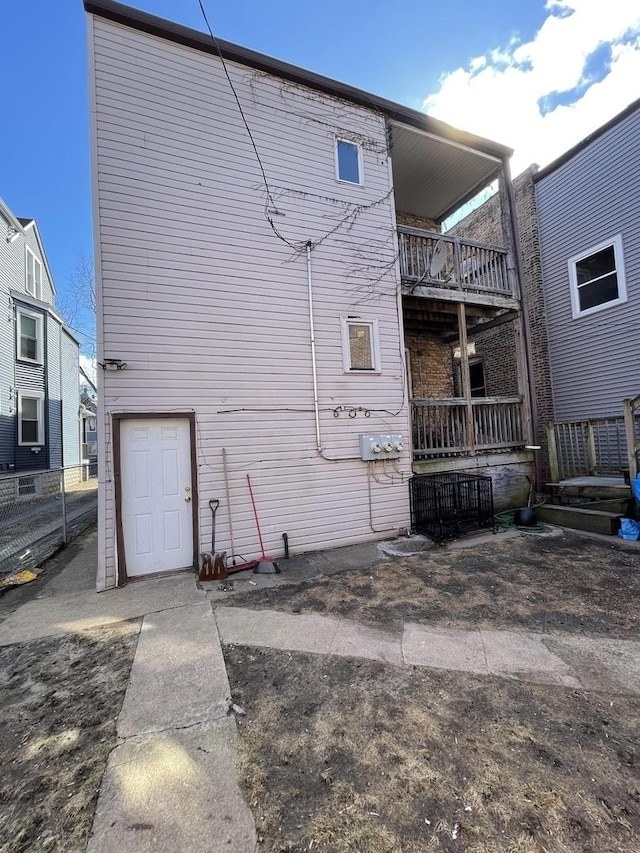back of house with cooling unit and a balcony