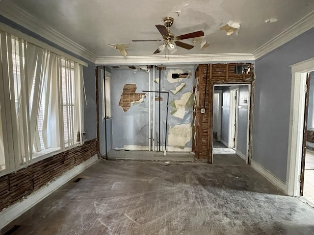 spare room with ceiling fan, ornamental molding, and baseboards