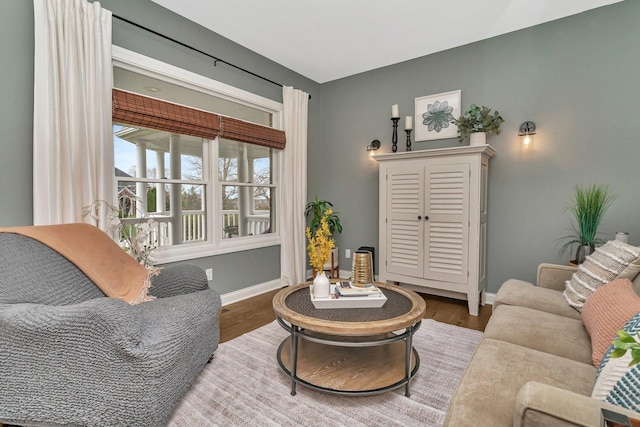 living area with wood finished floors and baseboards