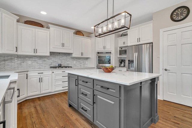 kitchen featuring stainless steel appliances, gray cabinetry, and white cabinets