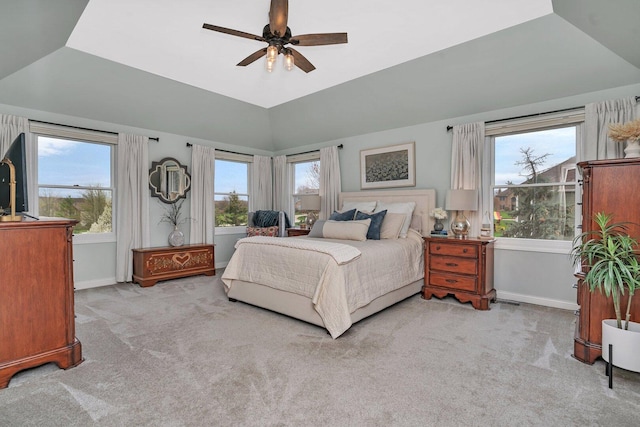 bedroom featuring multiple windows, ceiling fan, carpet flooring, and baseboards