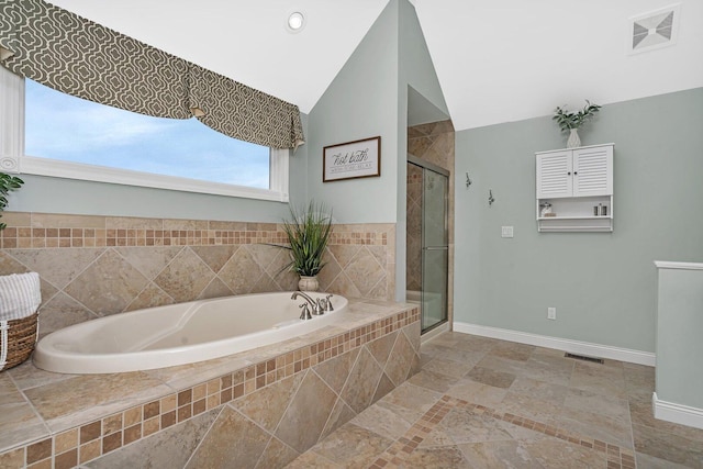 bathroom with a garden tub, a stall shower, visible vents, and baseboards