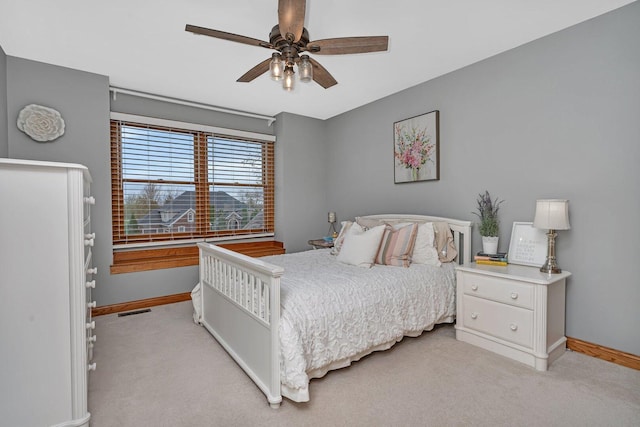 bedroom featuring baseboards, a ceiling fan, and light carpet