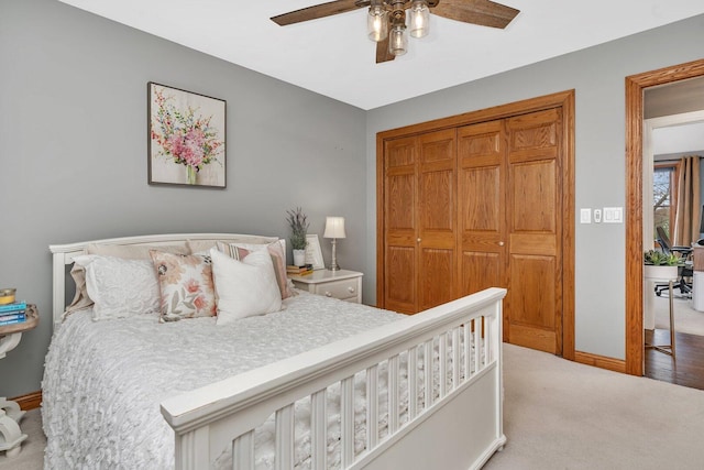 carpeted bedroom featuring ceiling fan, baseboards, and a closet