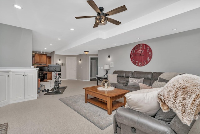 living room featuring light colored carpet, a ceiling fan, recessed lighting, and baseboards