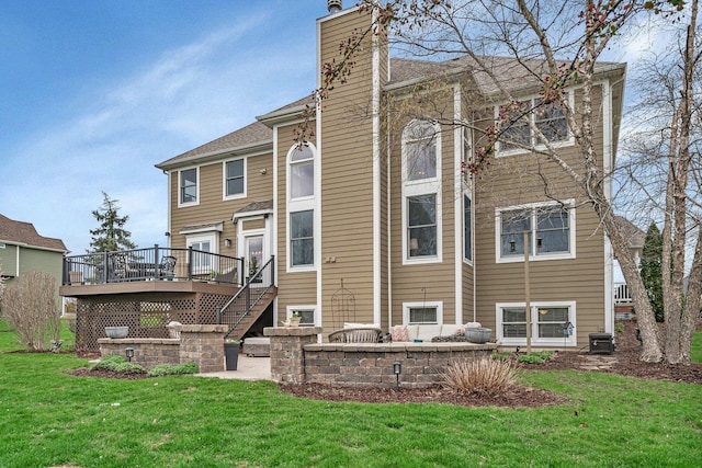 back of property featuring a wooden deck, a chimney, a lawn, stairway, and central AC unit