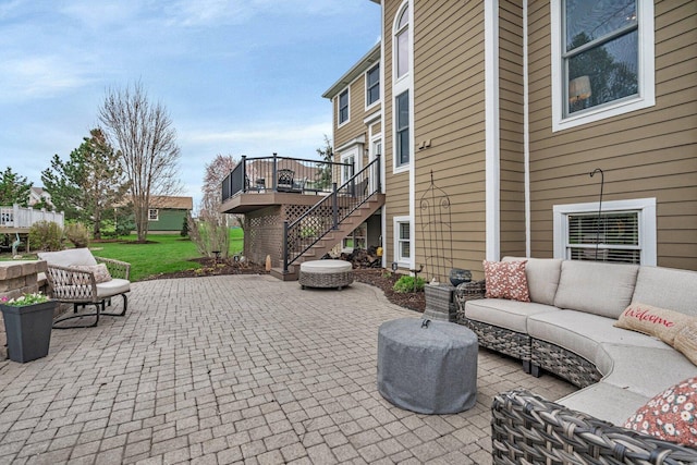 view of patio featuring an outdoor hangout area, a wooden deck, and stairway