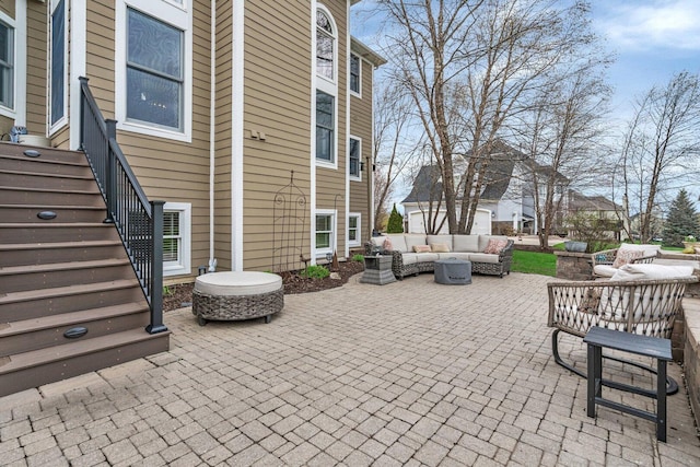 view of patio / terrace featuring an outdoor living space and stairs