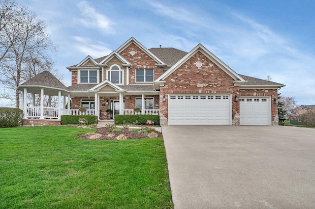 craftsman inspired home with covered porch, brick siding, driveway, a front lawn, and an attached garage