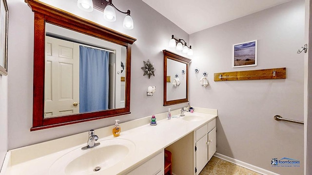 8400 Howe Rd, Wonder Lake, IL 60097 - full bathroom featuring double vanity, tile patterned floors, baseboards, and a sink