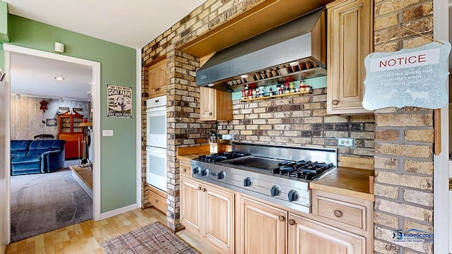 8400 Howe Rd, Wonder Lake, IL 60097 - kitchen with stainless steel gas cooktop, white double oven, light brown cabinets, light wood-style flooring, and wall chimney exhaust hood