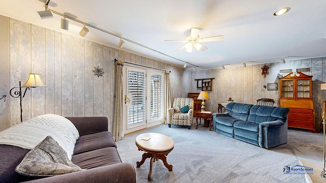 8400 Howe Rd, Wonder Lake, IL 60097 - living area with rail lighting, ceiling fan, wood walls, and carpet flooring