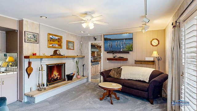 8400 Howe Rd, Wonder Lake, IL 60097 - living room featuring a brick fireplace, a ceiling fan, carpet flooring, and ornamental molding