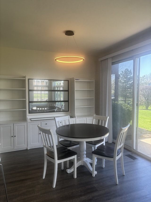 dining space with visible vents and dark wood finished floors