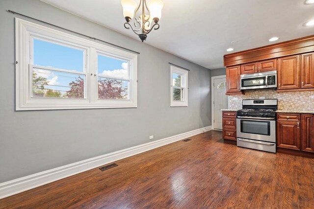 5932 107th Pl, Chicago Ridge, IL 60415 - kitchen with visible vents, baseboards, dark wood-style floors, an inviting chandelier, and stainless steel appliances