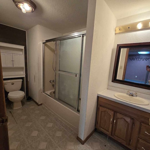 full bath with shower / bath combination with glass door, a textured ceiling, toilet, and vanity