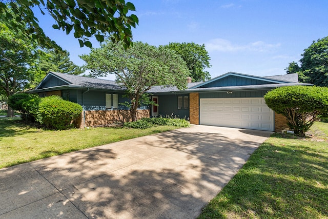 1204 Harrington Dr, Champaign, IL 61821 - single story home with brick siding, concrete driveway, a front lawn, an attached garage, and board and batten siding
